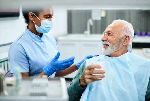 patient talking to dentist about implant salvage