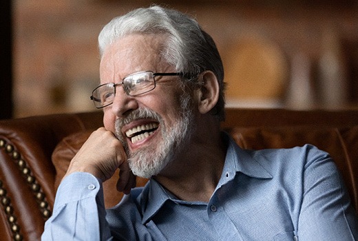 Man with All-On-4 smiling on couch