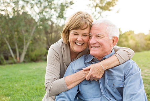 Smiling couple with dental bridge in Lynchburg