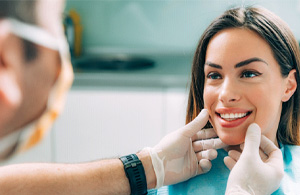 A dentist explaining the cost of cosmetic dentistry to a patient