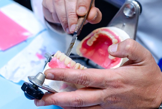 a dentist crafting full dentures