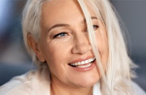 woman smiling after getting implants