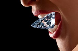 Close-up of a woman biting down on some ice