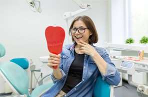 A woman about to follow dental implant post-op instructions in Lynchburg