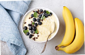 A banana smoothie bowl with blueberries