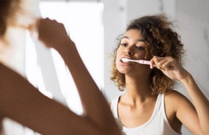 A woman brushing her teeth