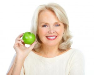 woman smiling preparing eat apple