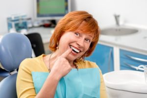 older woman smiling with dental implant