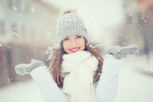 woman smiling in the snow during winter