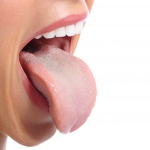 Woman’s tongue showing oral hygiene best practices