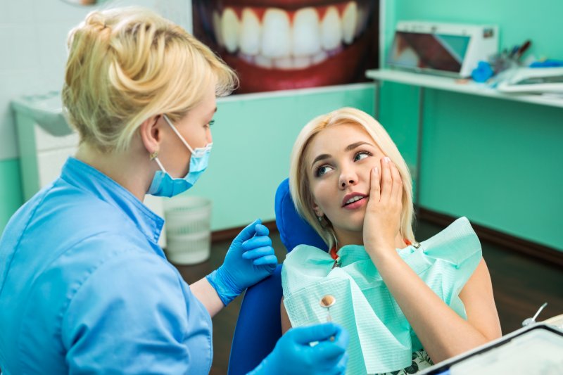 patient talking to emergency dentist about facial swelling