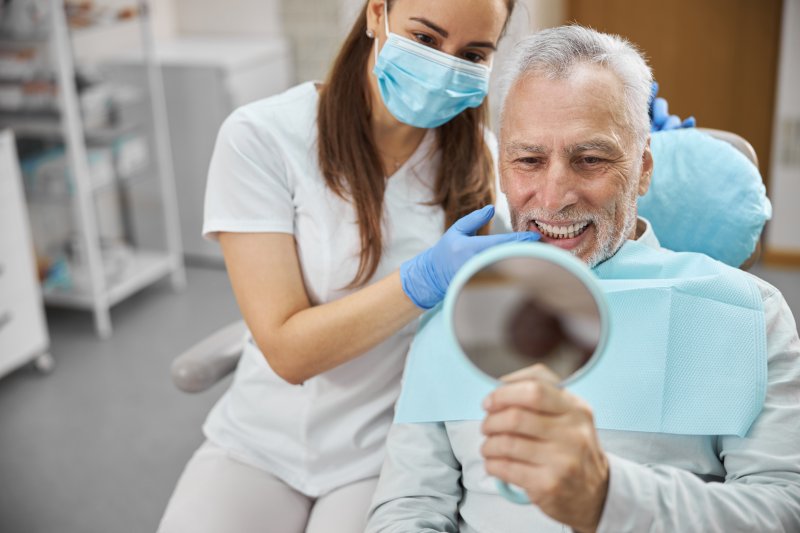 A confident older man happy with his dental implants