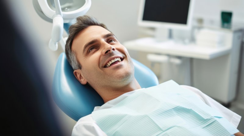 A man smiling after having his dental filling replaced.